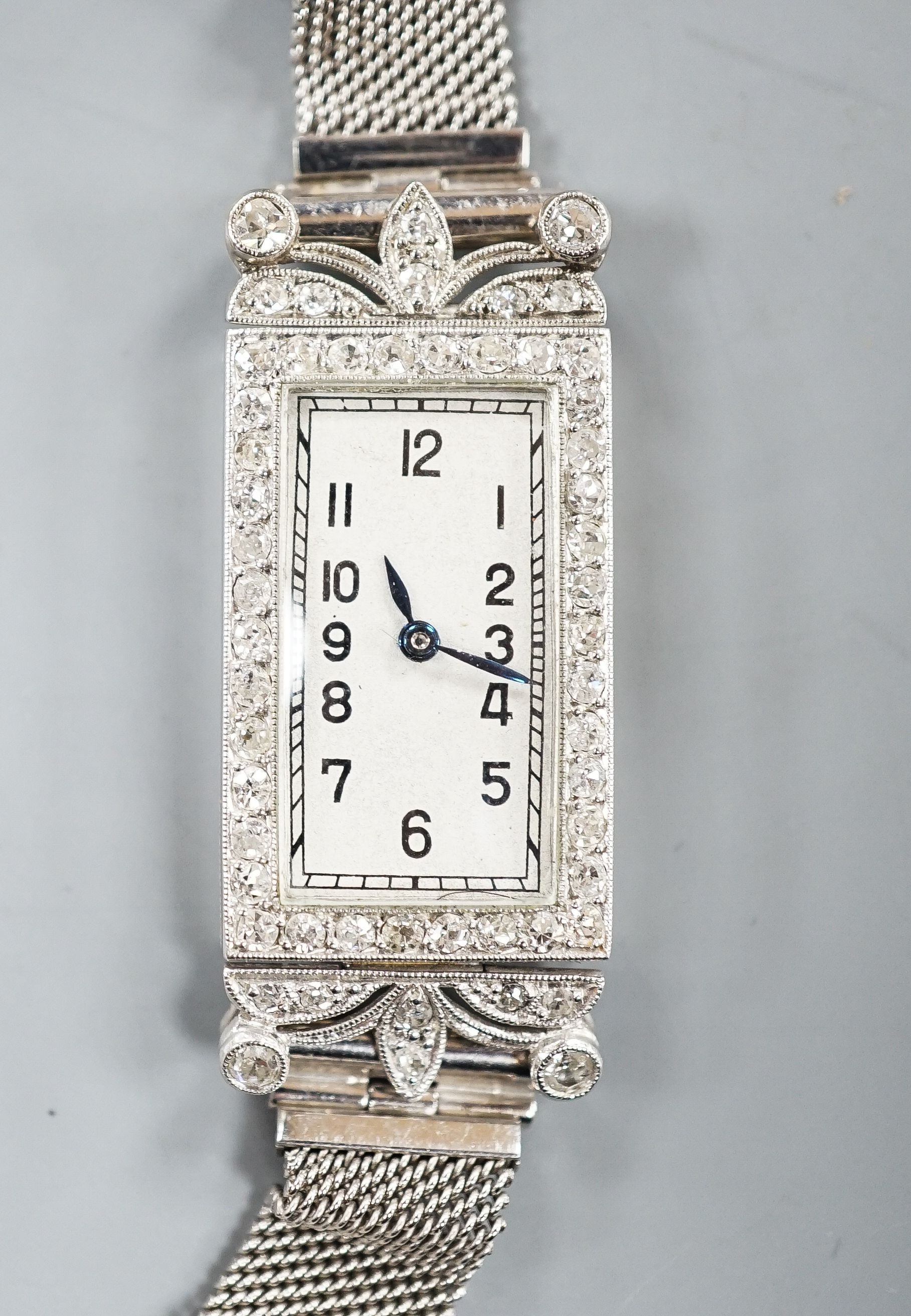 A lady's early 1970's white metal and diamond set cocktail watch (engraved Platine), on a 9ct white gold bracelet, case diameter 16mm, gross weight 21.4 grams.